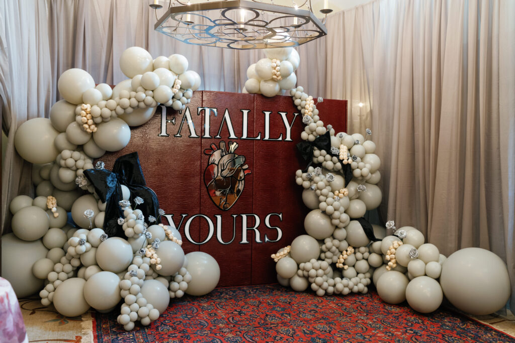 balloon arch, leather backdrop, wedding planning and design, black bow decor, silver roses