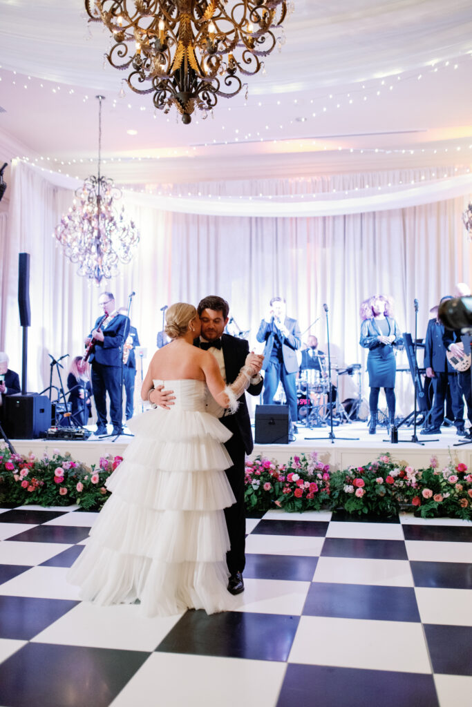 army navy country club wedding, washington d.c. luxury wedding planner and designer, washington d.c. wedding, pink wedding, summer wedding, wedding reception, bride and groom, bridal dress, tulle layered bridal dress, checkered wedding dance floor, wedding stage florals