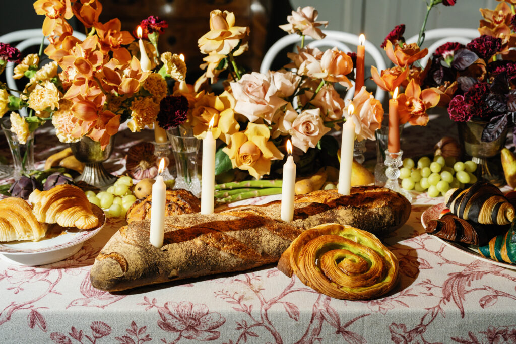 france wedding venue, burgundy wedding venue, french castle wedding venue, wedding planning and design, destination planner, france wedding, burgundy france, wedding tablescape, wedding tablescape design, bridal gloves, croissant, colorful croissants, candles in baguette