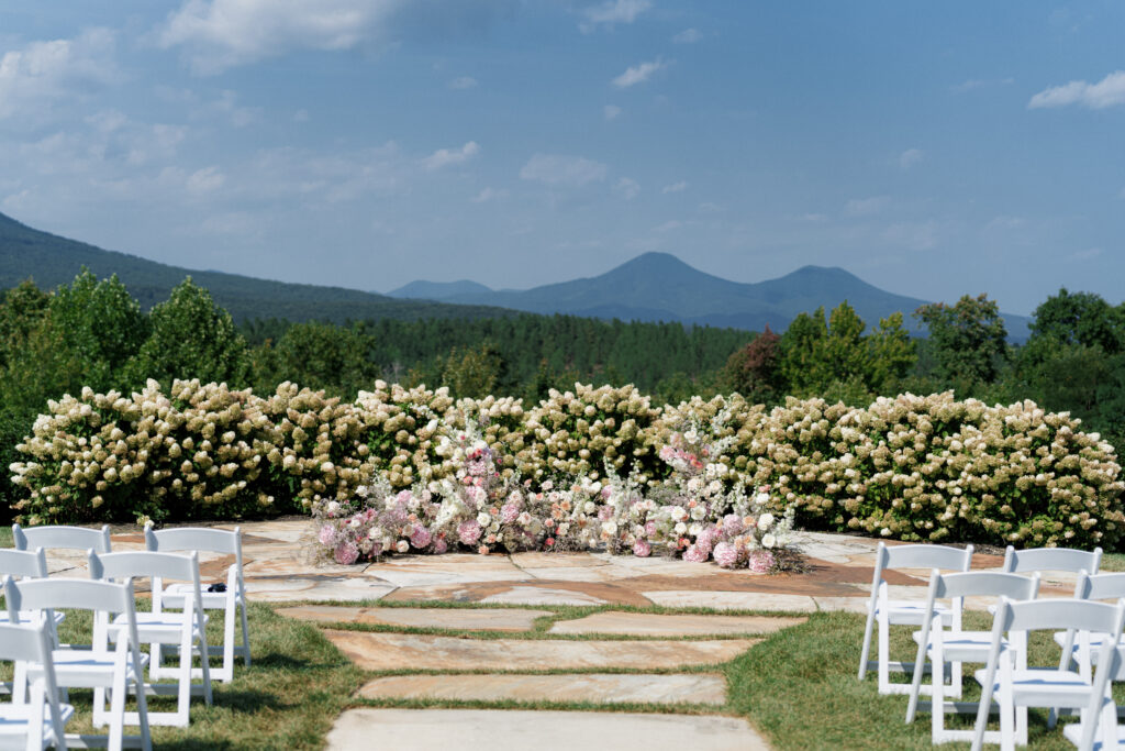 the seclusion wedding, wedding ceremony, ceremony white pink florals, outdoor wedding, summer wedding, luxury wedding planner, grounded ceremony arch