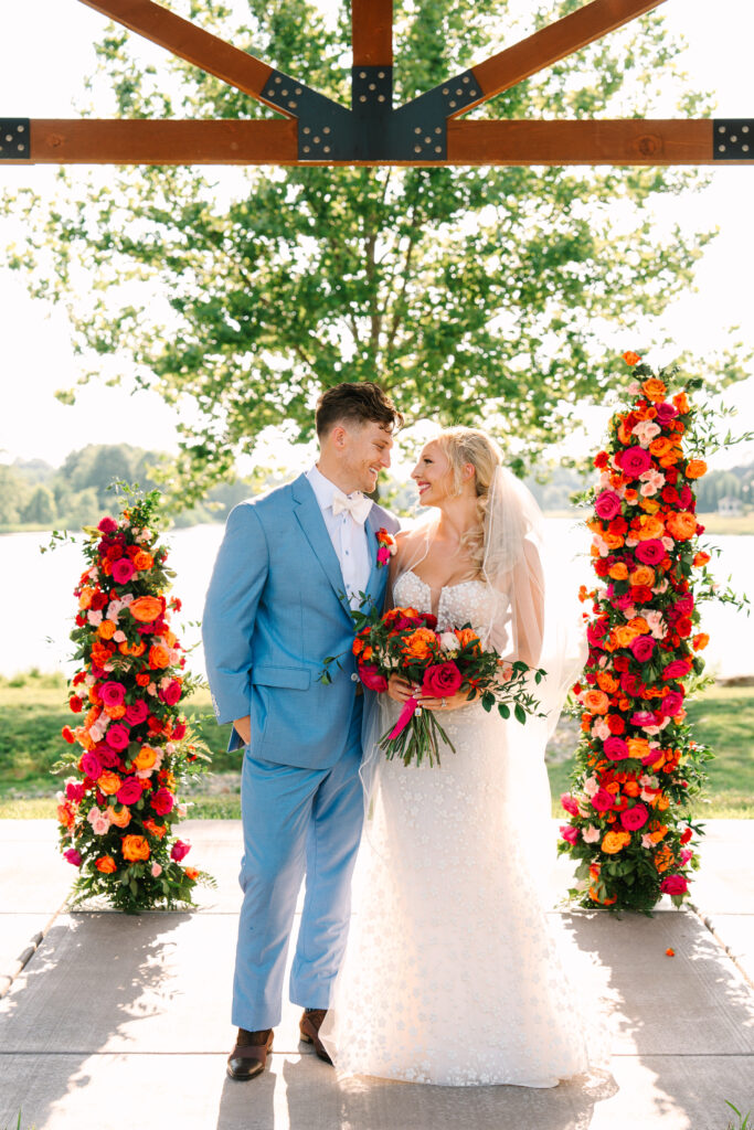 washington dc wedding planner, dmv wedding planner, destination wedding planner, indiana wedding planner, wedding flower arch, wedding ceremony altar, colorful wedding, bride and groom, colorful bridal bouquet, light blue groom suit, wedding ceremony