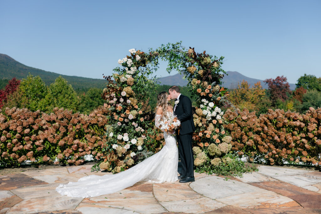 the seclusion wedding, fall wedding, ceremony, ceremony flower arch, fall wedding flowers, bride and groom, altar decor