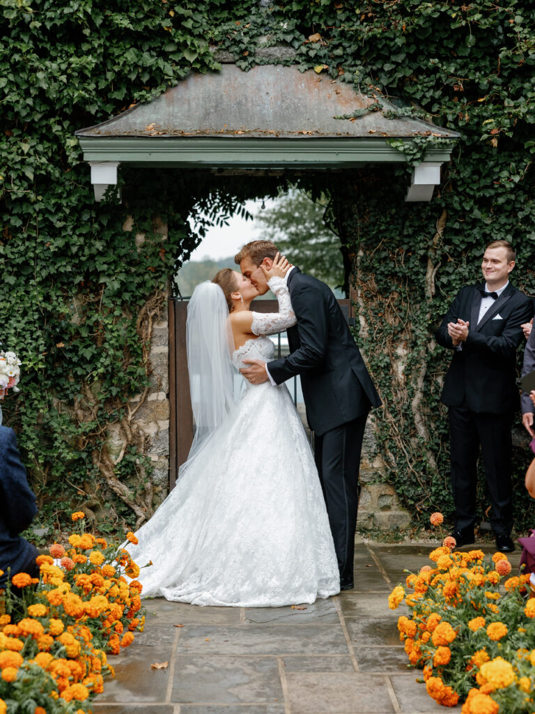 goodstone inn wedding, tented wedding, virginia wedding, luxury wedding, luxury wedding planner, orange wedding, outdoor wedding, ceremony, ceremony florals, orange wedding florals, orange carnations, bride and groom at the altar