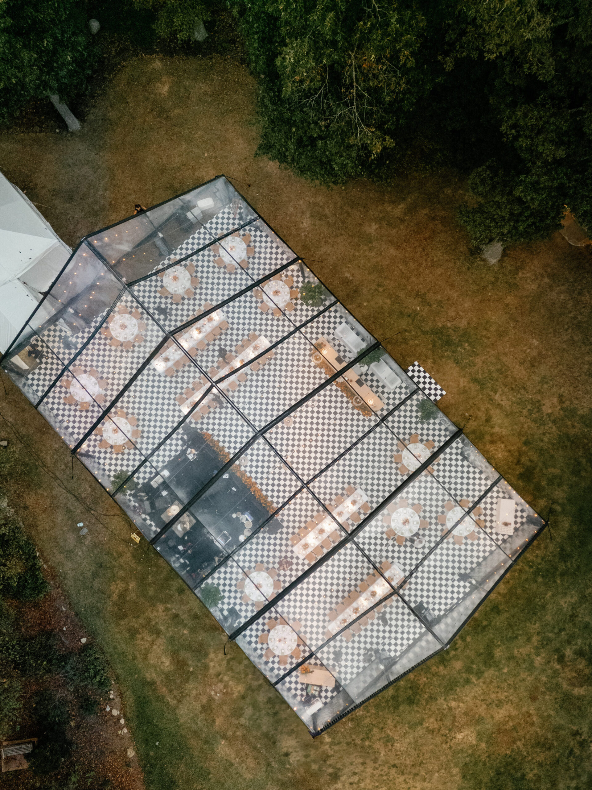 goodstone inn wedding, tented wedding, virginia wedding, luxury wedding, luxury wedding planner, orange wedding, outdoor wedding, reception, tented reception, black navitrac tent, wedding reception, checkered tented floor, tent drone shot