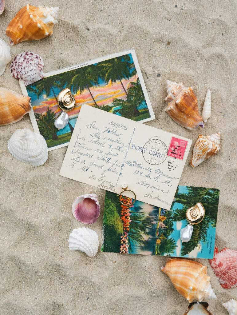 flatlay, wedding flatlay, wedding ring, engagement shoot, engagement ring, florida post card, seashells, seashell flatlay